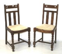 Two 20th century oak dining chairs.