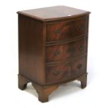 A small mahogany veneered bow fronted chest of drawers.