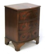 A small mahogany veneered bow fronted chest of drawers.