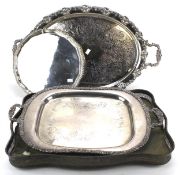 A collection of three large silver plated trays and another.