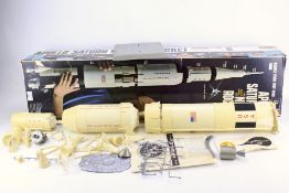 A Revell 1/96 Apollo Saturn V moon rocket model kit, partially built.