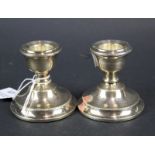 A pair of short round silver candlesticks with beaded bands. Hallmarks for Birmingham 1967, 6.