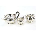 A silver plated three-piece tea set retailed by Harrods.