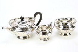 A silver plated three-piece tea set retailed by Harrods.