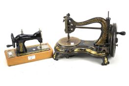 An early 20th century Jones's hand sewing machine and a smaller sewing machine.