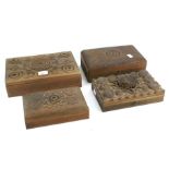 Four heavily carved wooden boxes. All of rectangular form with scroll decoration, some with keys.