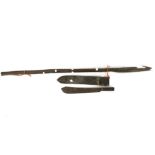A machete in original sheath and three wooden handled spears.