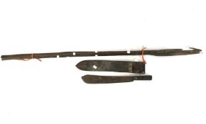 A machete in original sheath and three wooden handled spears.