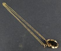 A 9ct gold gem set pendant on a chain. Of abstract form, 4.