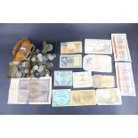 An assortment of 19th and 20th century world coins and bank notes.