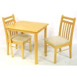 A contemporary pine table and pair of chairs.