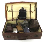 A leather suitcase containing assorted collectables.