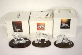 A Swarovski crystal figure set of three African animals. Including lion, elephant 8.