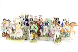 An assortment of Staffordshire pottery figures.