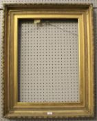 A large gilt wood picture frame.