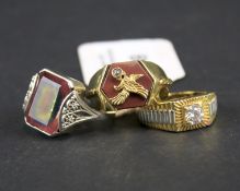 Three silver and white metal gentleman's rings. One decorated with an eagle, 26.