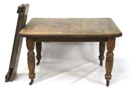 An early 20th century oak table with two leaves.