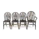 A contemporary set of three stained oak wheelback chairs and a single carver chair.