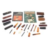 A collection of 20th century cheroot and cigarette holders in cases.