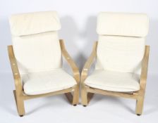 A pair of beech framed Ikea elbow chairs.
