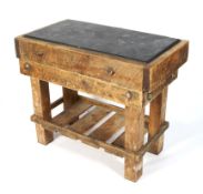 A vintage wooden butcher's block. Fitted with slate top, on base of plank construction, L105.