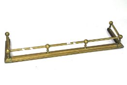 A 20th century brass fender.