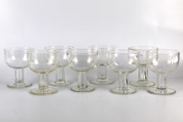 A set of eight glass dishes on stem.