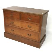 A mahogany chest of drawers with inlaid detail.