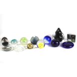 Twelve assorted glass paperweights.