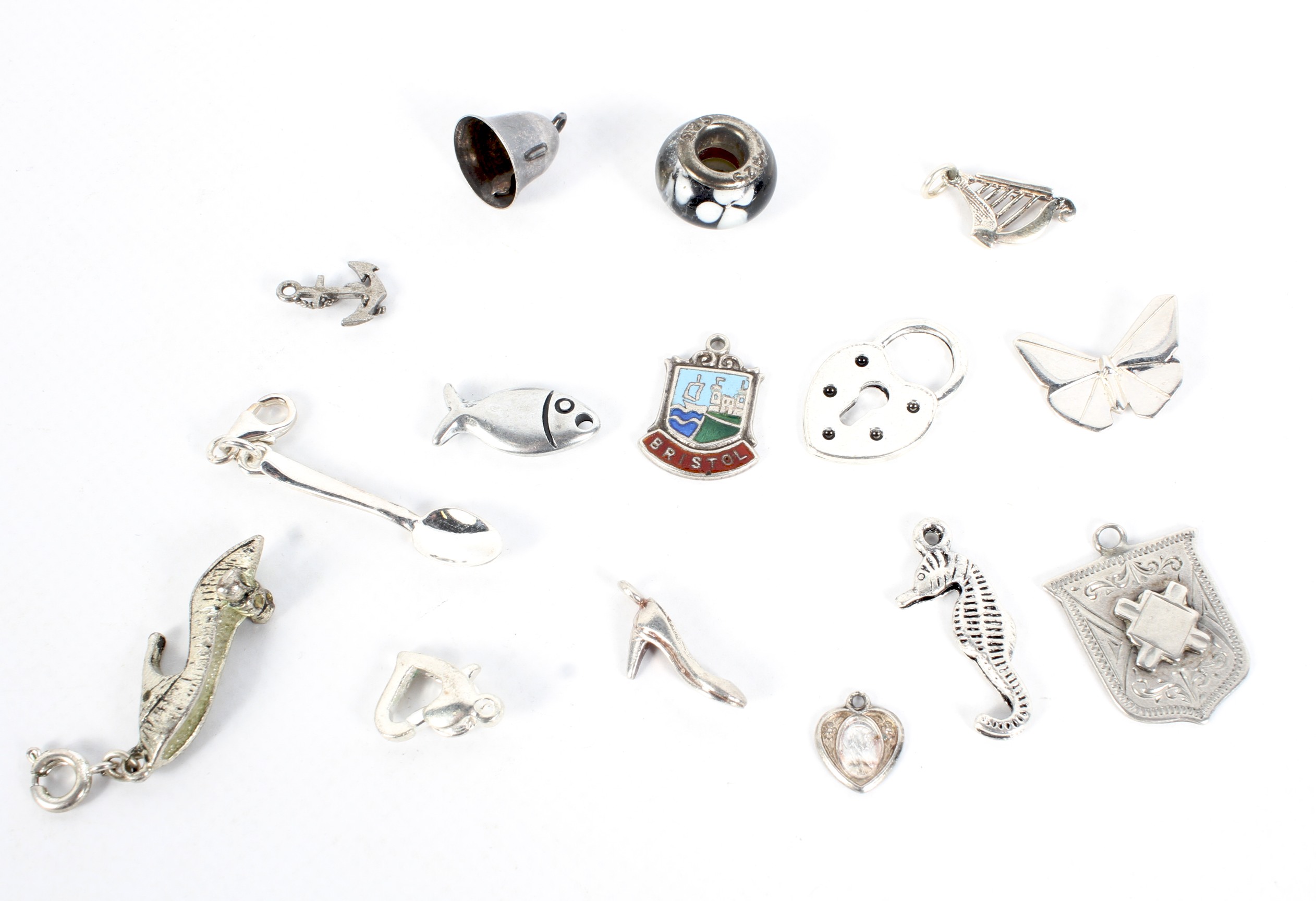 Fifteen silver and white metal charms.
