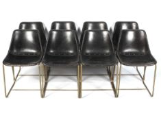 A set of eight retro style chairs.