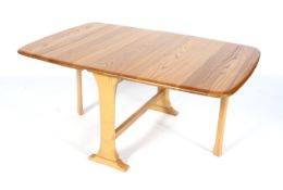 An Ercol style beech and elm dropleaf gateleg coffee table.
