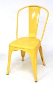 A yellow painted metal cafe garden chair.