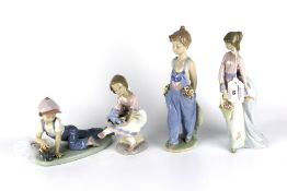 Four Lladro Collectors Society figures.