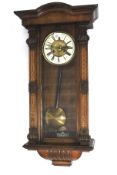 A Vienna style mahogany wall clock. Striking, pendulum and key.