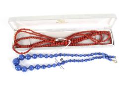 A carnelian double strand necklace and a lapis lazuli necklace.