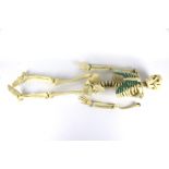 A vintage plastic model of a human skeleton. Approximately 77cm long. Top of the skull is missing.