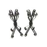 A pair of wrought iron stands. Of scroll design, 84cm high.