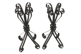 A pair of wrought iron stands. Of scroll design, 84cm high.