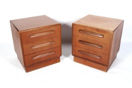 A pair of G-Plan bedside tables. Each with three drawers, on plinth bases, bearing E.