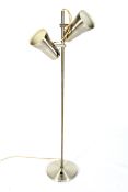 A brushed metal adjustable floor lamp. With two spot lights on a single column, 125cm high.