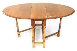 A light oak gate leg dining table.