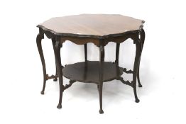An Edwardian mahogany centre table. With pie crust top and a shelf below, label John Davis & Co.