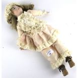 A bisque head doll. Marked 'RD 88', with painted features, glass eyes, bisque hands and feet.