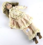 A bisque head doll. Marked 'RD 88', with painted features, glass eyes, bisque hands and feet.