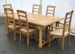 A large country style dining table and six matching rush seated chairs 4+2.