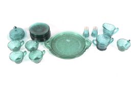A Jeanette Doric and Pansy pattern Depression Era press-moulded blue-green glass table service.