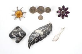 Six vintage silver and white metal brooches.