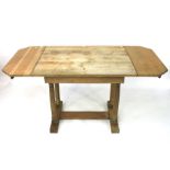 A contemporary oak drop leaf table.