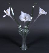 A group of 20th century Murano glass lilies and fronds in a trumpet shaped glass vase.